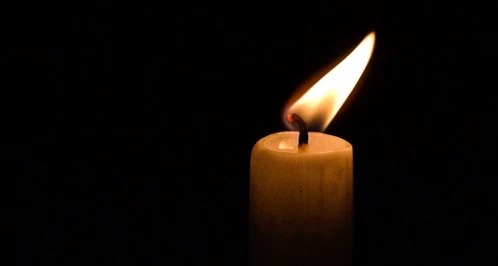 A candle flickering in the dark.
