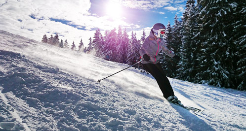 A woman skiing down a mountain.