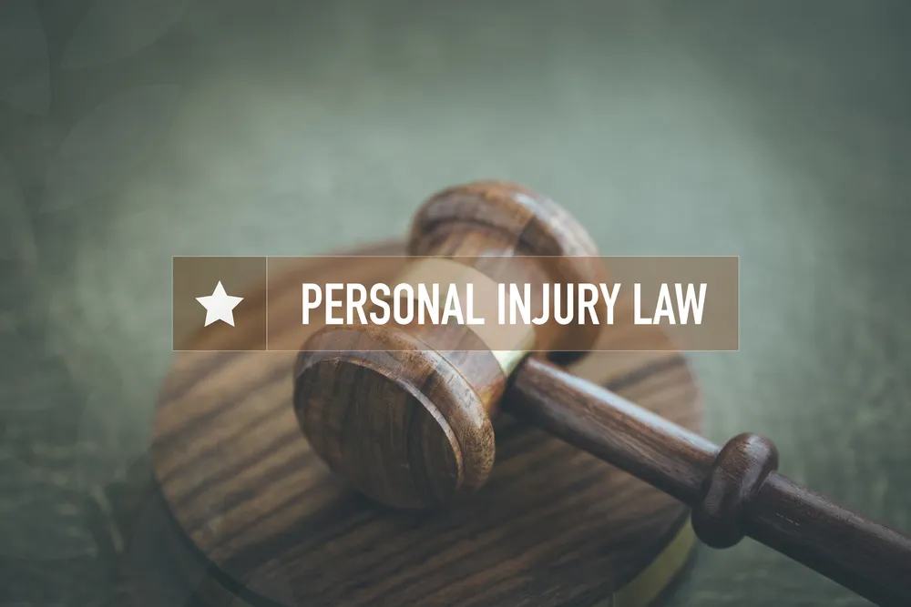 A gavel laying on its side with the words "personal injury law" superimposed over it.