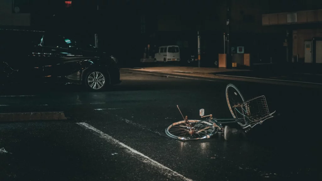 A crashed bicycle that was hit by a car. The rider is injured and needs to contact an auto accident lawyer in Kansas City.