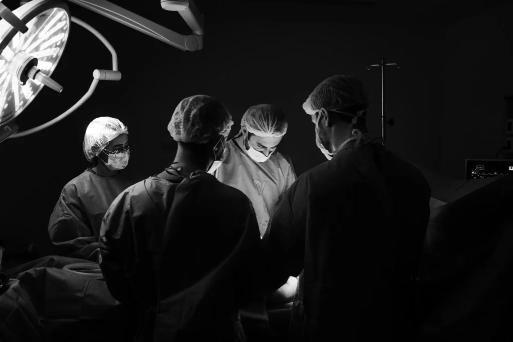 A group of surgeons discussing a surgical error they made. Patients injured due to negligence should contact a surgical error attorney in Kansas City.