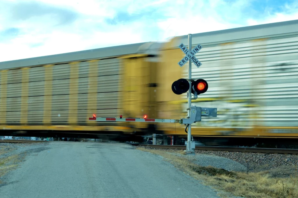 A train rolling by at a railroad crossing where a railroad accident recently occurred. It is wise to hire a railroad accident attorney.